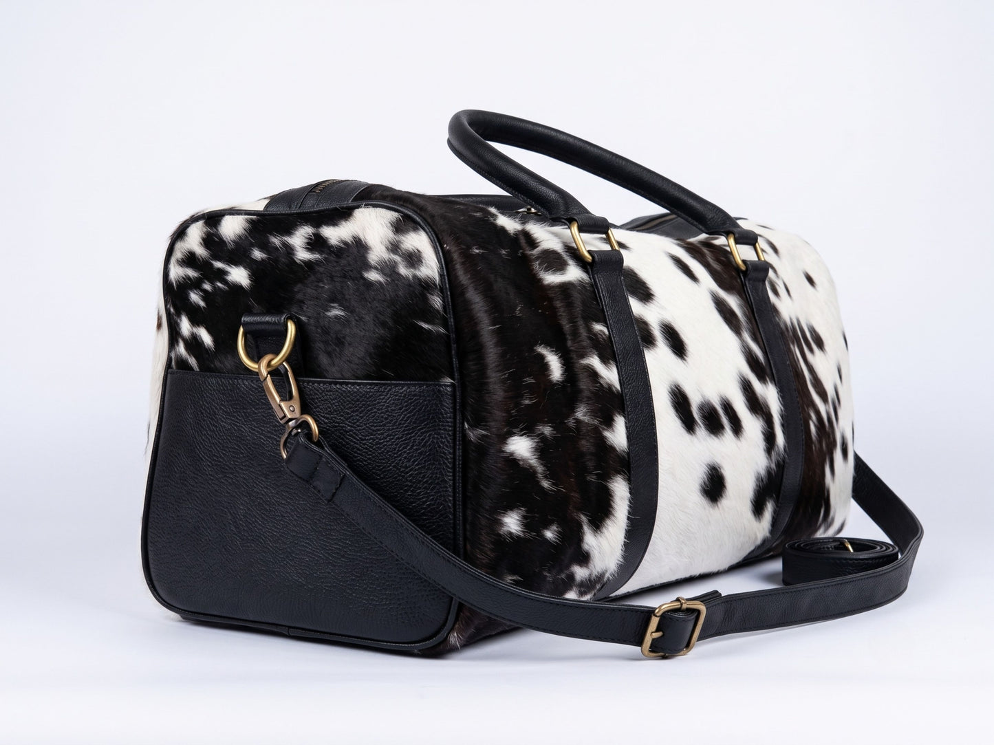 Hashmeers hair-on cowhide travel bag from the side with detachable leather shoulder strap